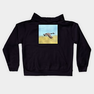 Canada Goose flying south for the Winter. Kids Hoodie